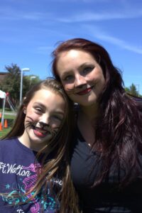 woman and girl with cat face paint at 3rd annual community celebration