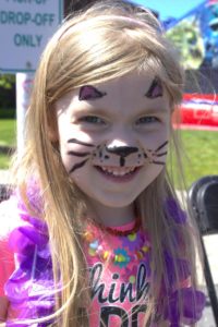 young girl with cat face paint at 3rd annual community celebration