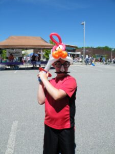 boy in balloon hat at 3rd annual community celebration