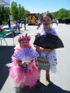 young girls with fans enjoying 3rd annual community celebration