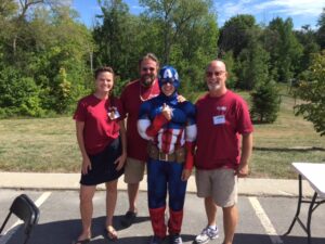 captain america with three volunteers at 2nd annual community celebration