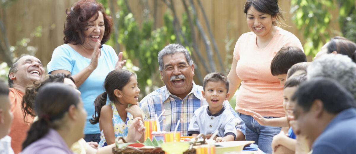 Three generation family sitting at a picnic table