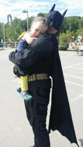 batman hugging a girl at 2nd annual community celebration