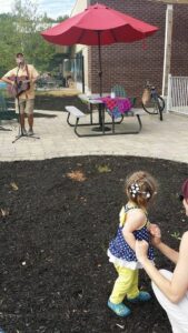 man singing with guitar at 2nd annual community celebration