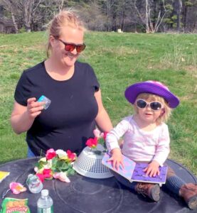 Mom and daughter outside reading